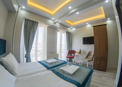 a hotel room with a bed and a table and chairs at Grand Esen Hotel in Istanbul