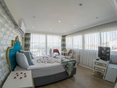 a bedroom with a large bed and a television at Grand Esen Hotel in Istanbul