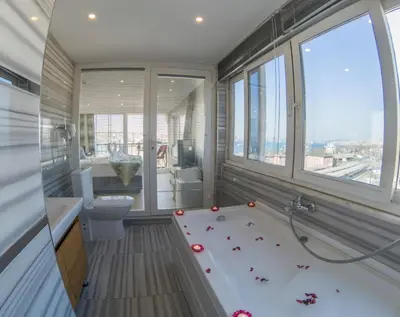 a bathroom with a bath tub with roses on the floor at Grand Esen Hotel in Istanbul