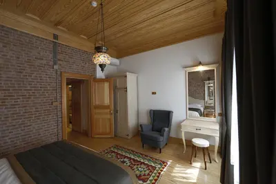a bedroom with a bed and a chair in a room at Catirga Konak Apartments in Istanbul