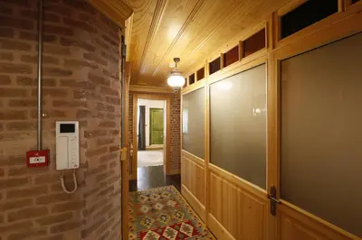 a hallway with a brick wall and a glass door at Catirga Konak Apartments in Istanbul