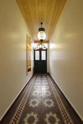 an empty hallway with a door and a rug at Catirga Konak Apartments in Istanbul