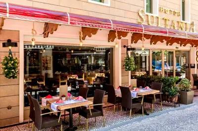 a restaurant with tables and chairs in front of a building at Hotel Sultania Boutique Class in Istanbul