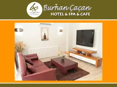 a living room with a couch and a tv at BC Burhan Cacan Hotel & Spa & Cafe in Istanbul