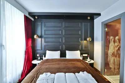 a bedroom with a large bed with a black wall at Senatus Hotel - Special Class in Istanbul