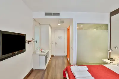 a bedroom with a bed and a television on a wall at Senatus Hotel - Special Class in Istanbul