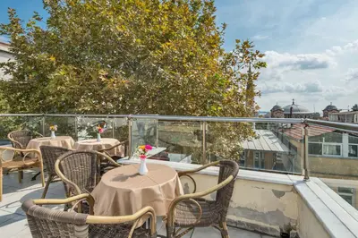 a row of tables and chairs on a balcony at May Hotel Istanbul in Istanbul