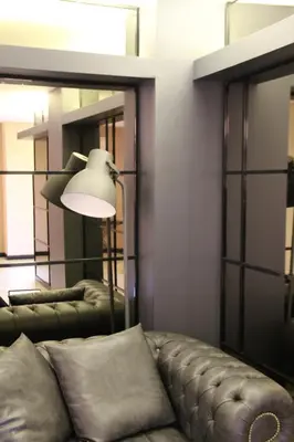 a living room with a leather couch and a lamp at Airport Residence in Istanbul