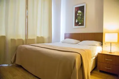 a bedroom with a bed and a lamp on a table at Airport Residence in Istanbul