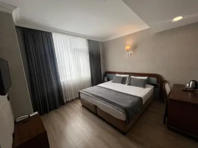 a hotel room with a bed and a window at Fuar Hotel in Istanbul