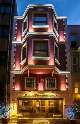 a tall red building with tables in front of it at Amofta Hotel Taksim in Istanbul