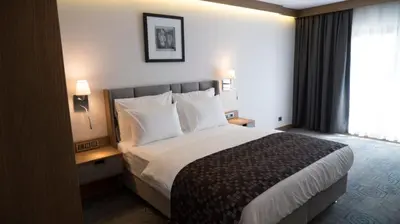 a hotel room with a large bed and a window at Yuksel Istanbul Yenikapı Hotel in Istanbul