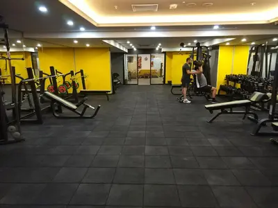 a man and a woman standing in a gym at Heybeli Hotel in Mudanya