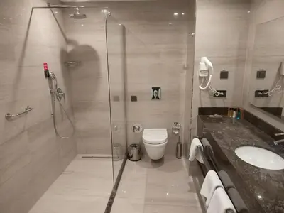 a bathroom with a shower and a toilet and a sink at Heybeli Hotel in Mudanya