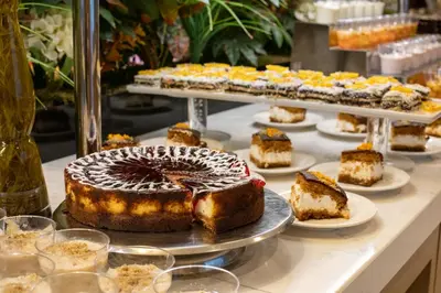 a table topped with cakes and other desserts on plates at Golden Age Hotel Taksim in Istanbul