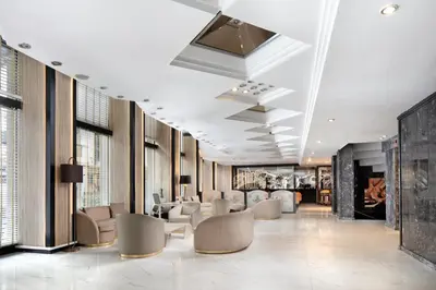 a lobby with a waiting area with chairs and tables at Golden Age Hotel Taksim in Istanbul