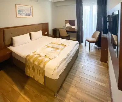 a hotel room with a bed and a desk at Hill River Hotel in Agva