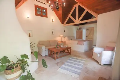 a living room with a couch and a table at Tranquilla River Lodge in Agva