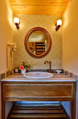 a bathroom with a sink and a mirror at Tranquilla River Lodge in Agva