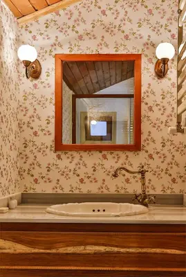 a bathroom with a sink and a mirror at Tranquilla River Lodge in Agva