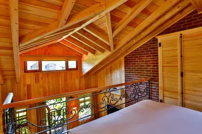 a room with a balcony with a iron railing at Tranquilla River Lodge in Agva