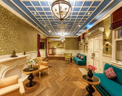 a lobby with a couch and tables and a chandelier at Hagia Sofia Mansions Istanbul, Curio Collection by Hilton in Istanbul