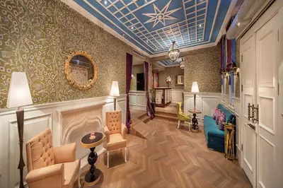 a living room with a blue ceiling at Hagia Sofia Mansions Istanbul, Curio Collection by Hilton in Istanbul