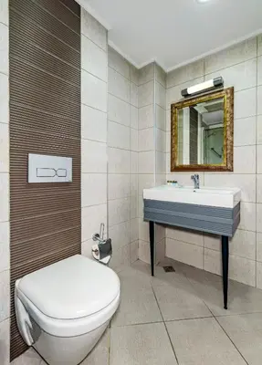 a bathroom with a toilet and a sink and a mirror at Tilia Hotel in Istanbul