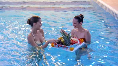two women in a swimming pool with a tray of fruit at İstanbul Trend Hotel Old City in Istanbul