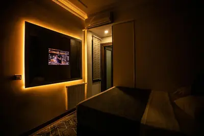 a bedroom with a bed and a tv on the wall at Hotel Pera Capitol - Taksim & İstiklal in Istanbul