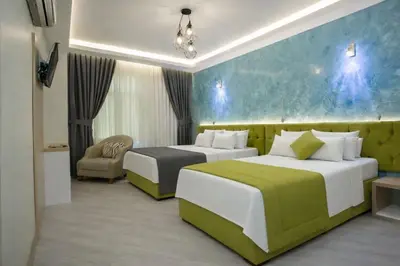 a hotel room with two beds and a couch at Hotel Pera Capitol - Taksim & İstiklal in Istanbul