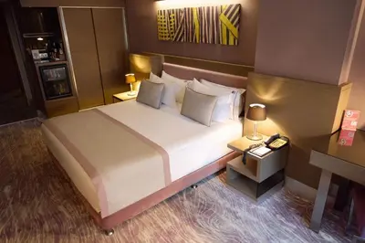 a bedroom with a large white bed with pillows at Avantgarde Urban Levent in Istanbul