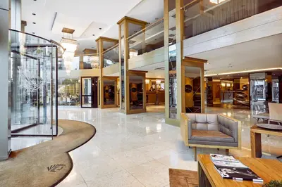 a lobby with a couch and a table in a building at Avantgarde Urban Levent in Istanbul