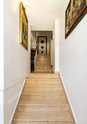 a staircase in a home with white walls and wood floors at Cheers Vera Edition Hotel in Istanbul