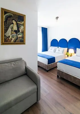 a hotel room with two beds and a couch at Cheers Vera Edition Hotel in Istanbul