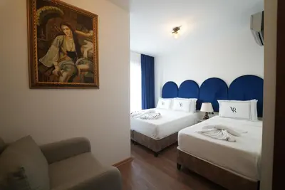a hotel room with two beds and a painting on the wall at Cheers Vera Edition Hotel in Istanbul