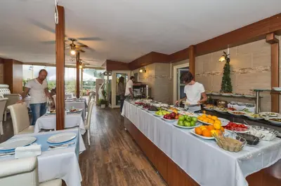 a buffet line in a restaurant with people preparing food at The Empress Theodora Hotel in Istanbul