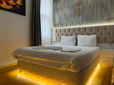 a bedroom with a large bed with a large headboard at Jasmine Apart & Boutique Hotel in Istanbul