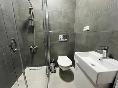 a bathroom with a shower and a toilet and a sink at Jasmine Apart & Boutique Hotel in Istanbul