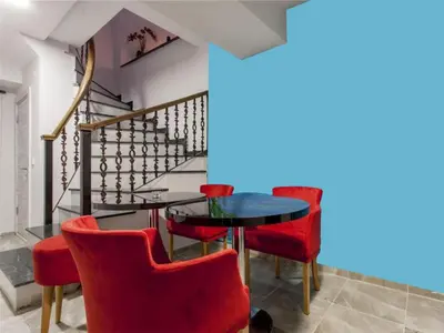 a dining room with red chairs and a glass table at Taksim Sem House in Istanbul