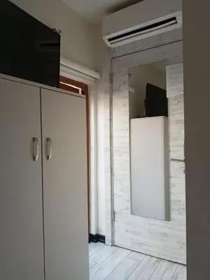 a living room with a refrigerator and a mirror at Taksim Sem House in Istanbul
