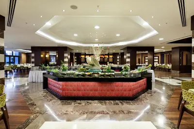 a lobby of a hotel with a large reception desk at The Green Park Pendik in Istanbul