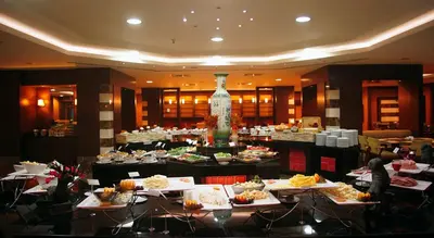 a restaurant with a table with plates of food at The Green Park Pendik in Istanbul