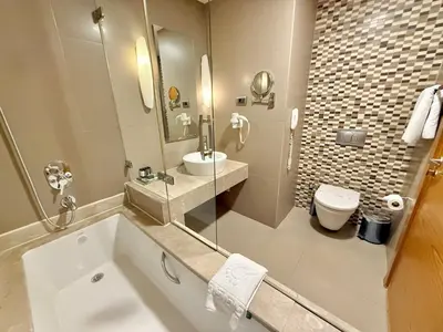 a bathroom with a tub and a sink and a toilet at The Green Park Pendik in Istanbul