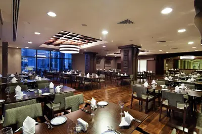 a dining room with tables and chairs in a restaurant at The Green Park Pendik in Istanbul