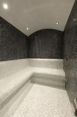 a bathroom with a bath tub with black tiles at Endless Art Hotel-Special Category in Istanbul