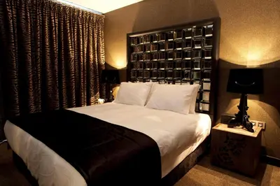 a bedroom with a large bed with a black headboard at Hypnos Design Hotel in Istanbul