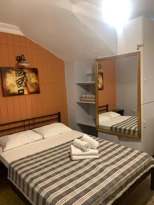 a bedroom with a bed and a mirror at Volare Apart in Istanbul