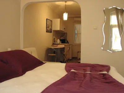 a bedroom with a bed and a mirror on the wall at Volare Apart in Istanbul