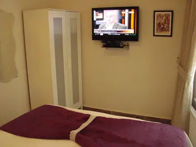 a bedroom with a flat screen tv on the wall at Volare Apart in Istanbul